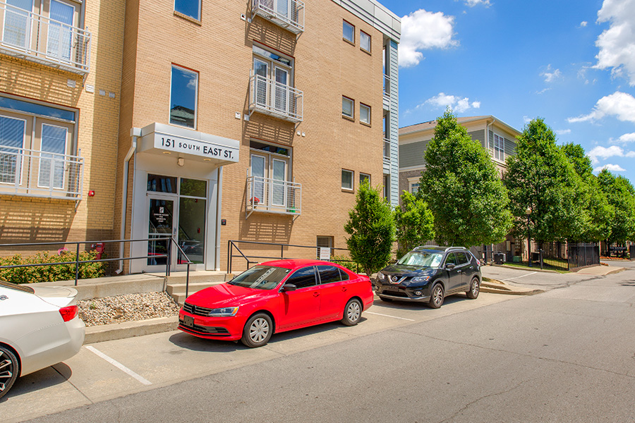 Drive courteously and cautiously around your neighborhood when you live in a community like Waverly Apartments. Several cars parked in front of the entrance located at Waverly Apartments.