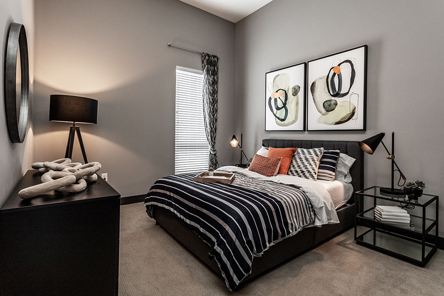 Use programmable smart lights and give the impression that you're home. Bedroom with lights on at Spark Apartments in Fishers