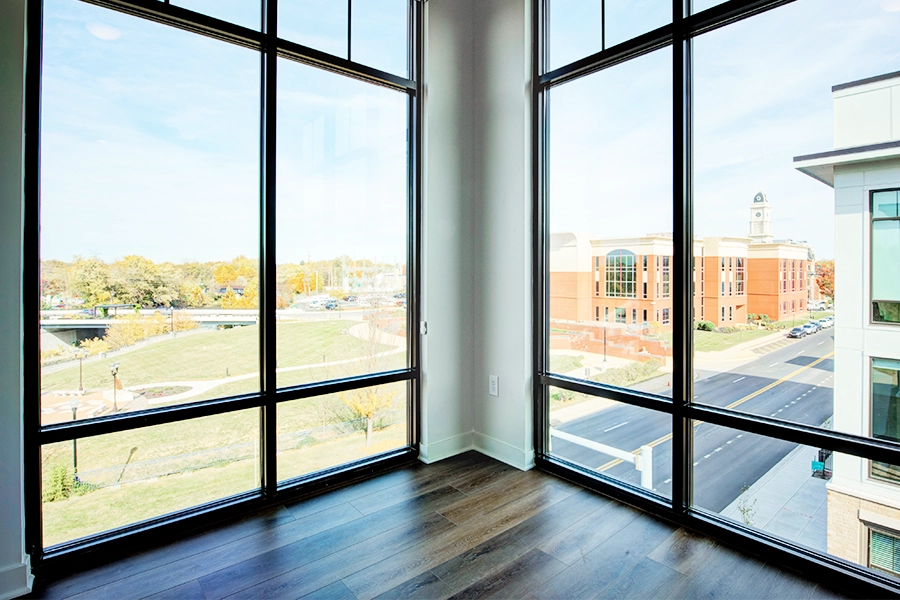 Floor-to-ceiling windows provide an impressive view outside from an apartment interior When choosing a floor plan, consider the amount of natural light. This unit at East Bank Apartments offers plenty of light and beautiful views from floor-to-ceiling windows.