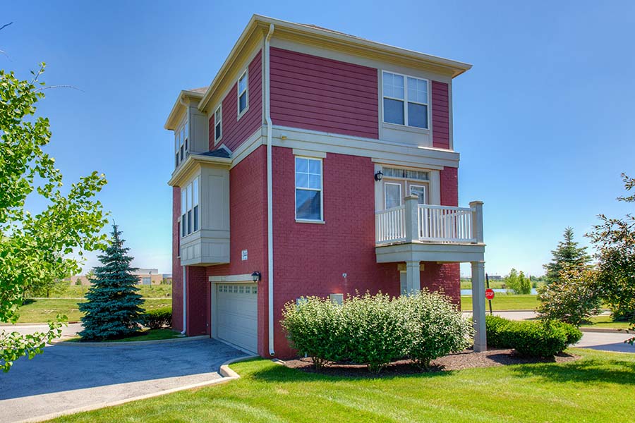 You'll enjoy garage parking when you rent a house, although some apartments like these townhomes at The District At Saxony have garages too. Red brick exterior of a townhome at The District At Saxony
