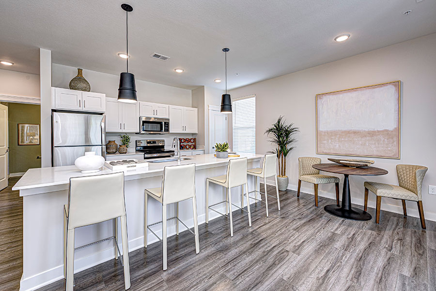 Plan to tour neighborhoods and apartment interiors like this one at Wheelhouse Apartments on the Monon. Kitchen with bar seating in a unit at Wheelhouse Apartments on the Monon