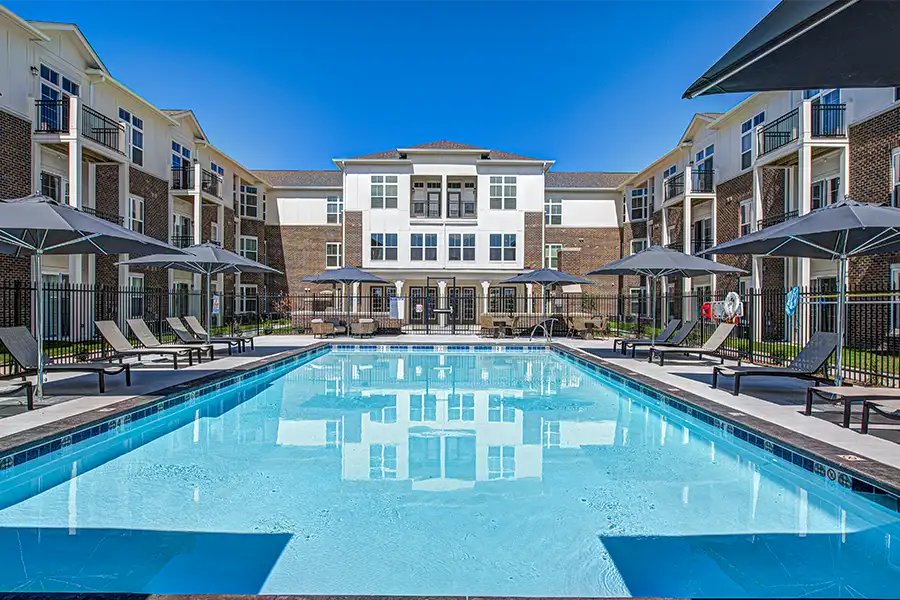 Pristine pool surrounded by apartment buildings at Hyde Park Apartments.